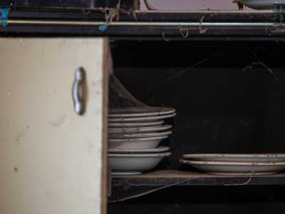 ...con dei piatti ricoperti dalla ragnatela che fanno capolino da una credenza retr�